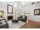 Open-concept living room with tile flooring, fireplace, and access to the backyard at 4065 Shadowind Way, Gotha, FL 34734