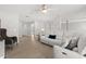 The living room features a comfortable white couch, wood flooring, ceiling fan, and natural light at 4065 Shadowind Way, Gotha, FL 34734
