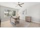 Bright office featuring a wooden desk, area rug, ceiling fan and natural light from a window with neighborhood views at 4065 Shadowind Way, Gotha, FL 34734