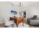 Inviting home office with stylish decor, comfortable seating, and an expansive work surface, with doors to dining area at 4065 Shadowind Way, Gotha, FL 34734