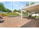 Covered outdoor patio with brick pavers, outdoor seating, hot tub, and backyard views at 4065 Shadowind Way, Gotha, FL 34734