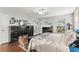 Comfortable bedroom features a ceiling fan, dark wood furniture, and natural light from a bright window at 407 Westchester Dr, Altamonte Springs, FL 32701
