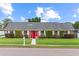 Charming single-story brick home with well-manicured lawn and bright red front door at 407 Westchester Dr, Altamonte Springs, FL 32701