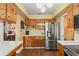 Modern kitchen featuring wood cabinets, stainless steel appliances, and breakfast bar at 407 Westchester Dr, Altamonte Springs, FL 32701