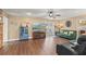 Spacious living room showcasing wood floors, neutral walls, a ceiling fan, and comfortable sofa seating at 407 Westchester Dr, Altamonte Springs, FL 32701