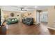 Open living room showcasing wood flooring, neutral walls, ceiling fan, and a comfortable sofa set at 407 Westchester Dr, Altamonte Springs, FL 32701