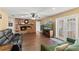 Bright living room featuring wood flooring, a brick fireplace, and a comfortable green sofa set at 407 Westchester Dr, Altamonte Springs, FL 32701