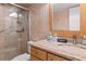Bright bathroom with granite counters, glass shower, and modern fixtures at 4153 S Atlantic Ave # 2120, New Smyrna Beach, FL 32169