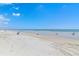 A serene beach view with soft sand and gentle waves under a clear blue sky at 4153 S Atlantic Ave # 2120, New Smyrna Beach, FL 32169