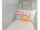 Whimsical chair displaying a sunshine-themed decorative pillow that enhances its appeal and charm at 4153 S Atlantic Ave # 2120, New Smyrna Beach, FL 32169