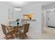 Bright dining area featuring wicker chairs, tile floors, and a view into the kitchen at 4153 S Atlantic Ave # 2120, New Smyrna Beach, FL 32169