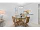 Charming dining area with wicker chairs, tile floor and a view into the kitchen at 4153 S Atlantic Ave # 2120, New Smyrna Beach, FL 32169