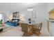 Cozy dining area with a glass table, wicker chairs, and a view into the living room at 4153 S Atlantic Ave # 2120, New Smyrna Beach, FL 32169