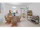 Inviting dining area features a round table, wicker chairs, and adjacent kitchen view at 4153 S Atlantic Ave # 2120, New Smyrna Beach, FL 32169