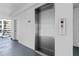 A modern elevator with stainless steel doors provides easy access to all floors of the building at 4153 S Atlantic Ave # 2120, New Smyrna Beach, FL 32169