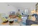 Comfortable living room with TV, coastal decor, plush seating, and balcony access at 4153 S Atlantic Ave # 2120, New Smyrna Beach, FL 32169