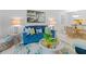 Bright living room featuring beach-themed decor, a comfortable blue sofa, and stylish furniture at 4153 S Atlantic Ave # 2120, New Smyrna Beach, FL 32169