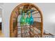 Wicker wine rack displaying colorful glassware; perfect for entertaining at 4153 S Atlantic Ave # 2120, New Smyrna Beach, FL 32169