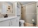 Bathroom features a white vanity with black hardware, walk-in shower, and a tall cabinet at 500 W Oakland Ave, Oakland, FL 34760