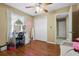 Bedroom with wood floors, a lighted vanity, and a large closet at 500 W Oakland Ave, Oakland, FL 34760