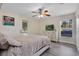Comfortable bedroom showcasing a dresser with a TV, a window, and an exterior door at 500 W Oakland Ave, Oakland, FL 34760