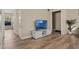Hallway view showcasing hardwood floors, neutral paint, and access to other rooms in the home at 500 W Oakland Ave, Oakland, FL 34760