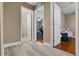 Hallway with open doorways to various rooms, including bedrooms and a bathroom, wood floors at 500 W Oakland Ave, Oakland, FL 34760