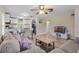 Open-concept living area with modern furniture, wood floors, and access to kitchen and laundry at 500 W Oakland Ave, Oakland, FL 34760
