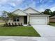 Charming one-story home featuring a pristine lawn and a two-car garage at 5132 Gopher Apple Dr, Apopka, FL 32712