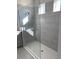 This luxurious walk-in shower features light-colored tile and a glass door at 605 Big Pine Ave, Minneola, FL 34715