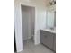 This bathroom features a quartz countertop, grey cabinetry and a separate toilet room at 605 Big Pine Ave, Minneola, FL 34715
