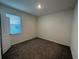Bedroom featuring neutral paint, brown carpet, and blinds allowing bright natural light at 605 Big Pine Ave, Minneola, FL 34715