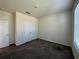 This bedroom has neutral walls, brown carpet, a double closet, and bright natural light at 605 Big Pine Ave, Minneola, FL 34715