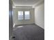 This light-filled primary bedroom features a tray ceiling and carpet at 605 Big Pine Ave, Minneola, FL 34715