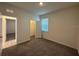 Bedroom featuring neutral paint, a double closet, brown carpet, and a view of the doorway and blinds at 605 Big Pine Ave, Minneola, FL 34715