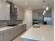 Modern kitchen boasting gray cabinets, stainless steel appliances, designer backsplash, and a large island at 605 Big Pine Ave, Minneola, FL 34715