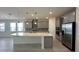 Spacious kitchen featuring an eat-in island, stainless steel appliances, and sleek gray cabinetry at 605 Big Pine Ave, Minneola, FL 34715