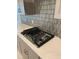 This modern kitchen features a sleek gas range and stylish backsplash at 605 Big Pine Ave, Minneola, FL 34715