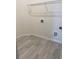 Laundry room with wood-look tile flooring, a wire rack, and hook-ups for a washer and dryer at 605 Big Pine Ave, Minneola, FL 34715