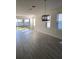 Bright living room featuring sleek tiled floors, large windows, and sliding glass doors to the backyard at 605 Big Pine Ave, Minneola, FL 34715