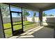 Screened-in porch featuring neutral flooring and walls, a door, and lovely backyard views at 605 Big Pine Ave, Minneola, FL 34715