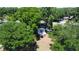 Aerial shot of the beautiful property surrounded by lush trees and a well-maintained lawn, offering privacy and tranquility at 6428 Lynn Rd, Orlando, FL 32810