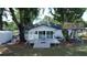 Back of house featuring a large deck, treehouse, and backyard at 6428 Lynn Rd, Orlando, FL 32810