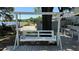 Enjoy outdoor relaxation on this backyard deck with a comfortable swing, perfect for enjoying the serene surroundings at 6428 Lynn Rd, Orlando, FL 32810