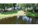 Aerial view of the backyard featuring lake access, a deck, and a treehouse at 6428 Lynn Rd, Orlando, FL 32810