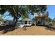 Charming home with a spacious backyard featuring a wooden deck, a swing, and a treehouse for outdoor enjoyment at 6428 Lynn Rd, Orlando, FL 32810