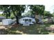 Aerial view of the backyard with a deck, storage shed, and mature trees at 6428 Lynn Rd, Orlando, FL 32810