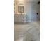Modern bathroom featuring marble-look tile and a frameless glass shower at 6428 Lynn Rd, Orlando, FL 32810