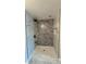 Updated bathroom with stylish marble-look shower and sleek fixtures at 6428 Lynn Rd, Orlando, FL 32810