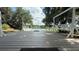 Inviting deck with a swing, hammock, and peaceful lake views at 6428 Lynn Rd, Orlando, FL 32810